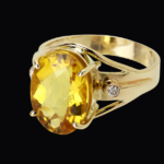 A topaz ring with white diamond inset into gold..