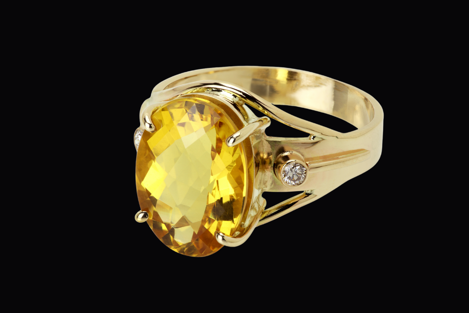A topaz ring with white diamond inset into gold..